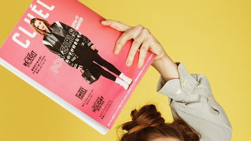photo of woman holding magazine