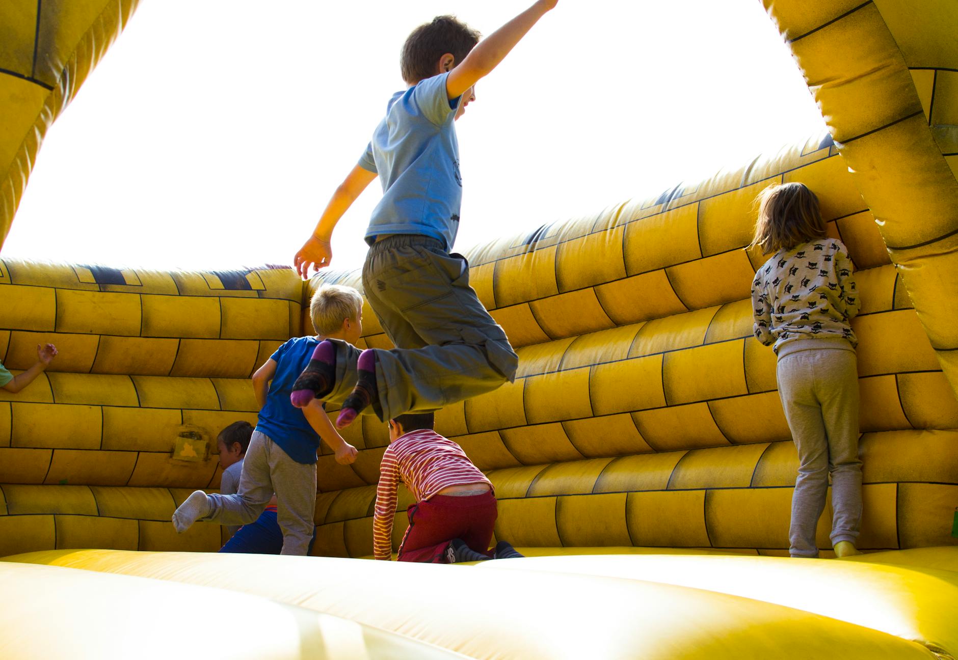 children playing on inflatable castle