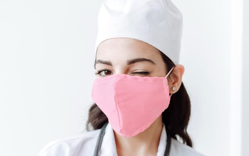 medical professional wearing face mask winking at the camera