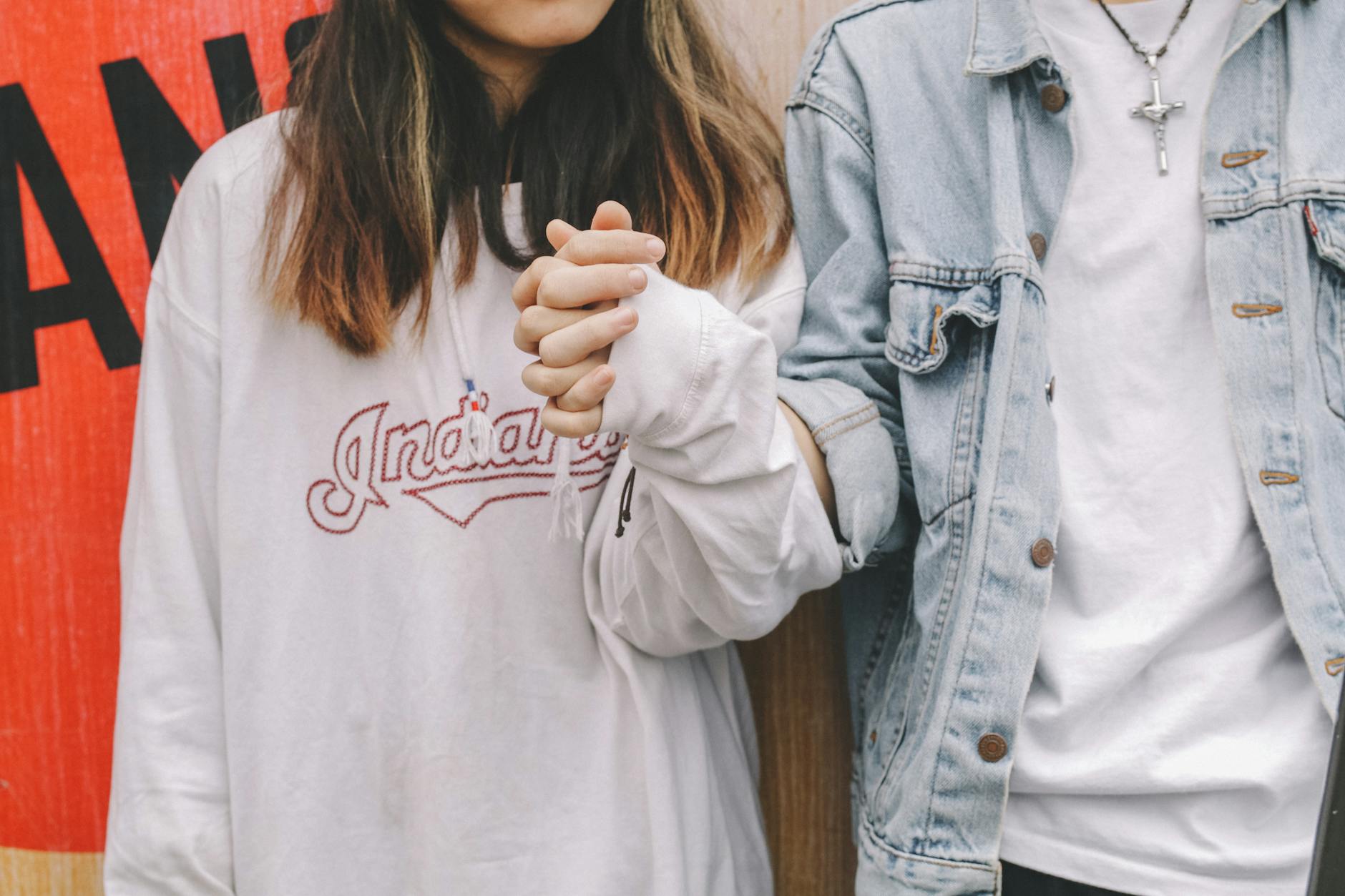 woman holding man s hand during day