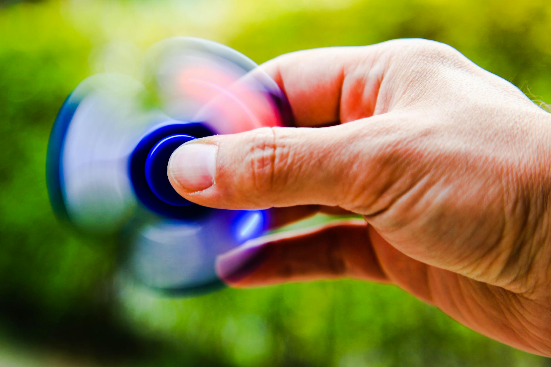 person playing blue hand spinner