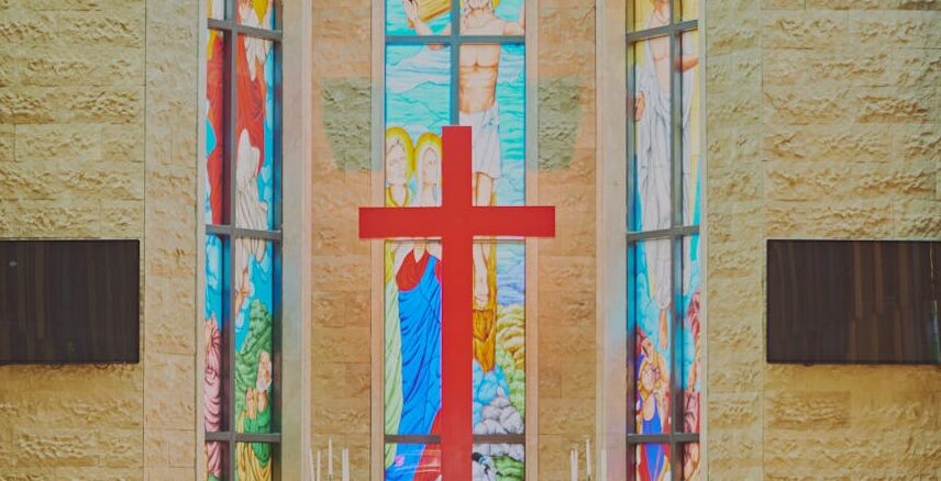 colorful stained glass windows illuminating church aisle
